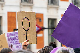 Women hands supporting feminist symbol placard on 8 M demonstration Women hands supporting feminist symbol placard on 8 M demonstration